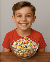 Child holding a bowl of colorful candies against a plain background
